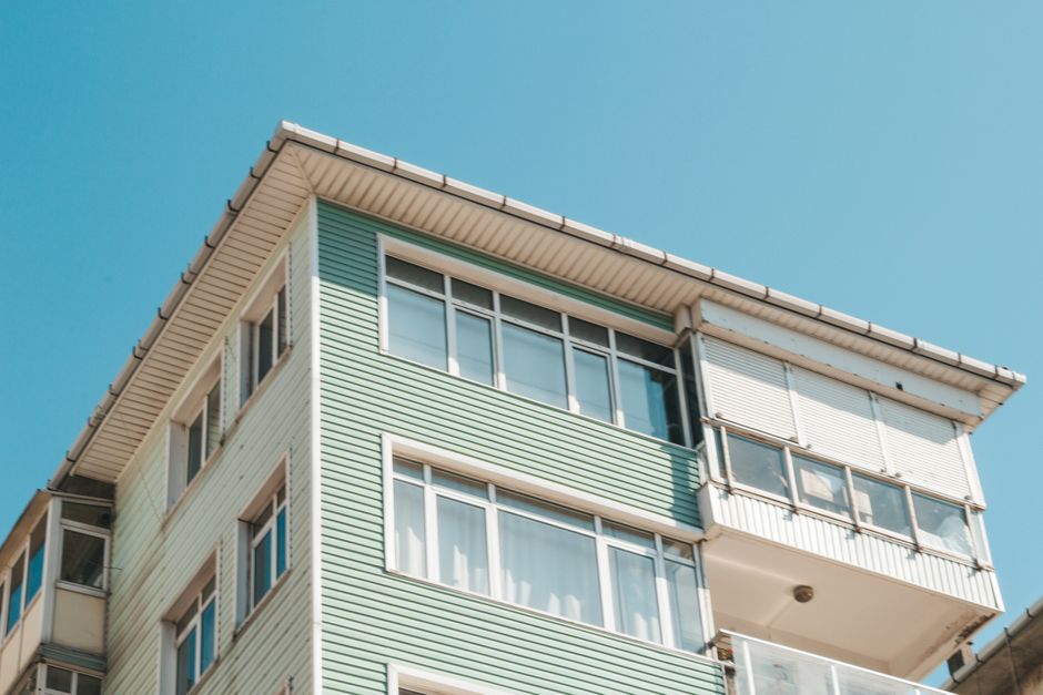 Low angle view of a modern apartment building exterior with glass windows